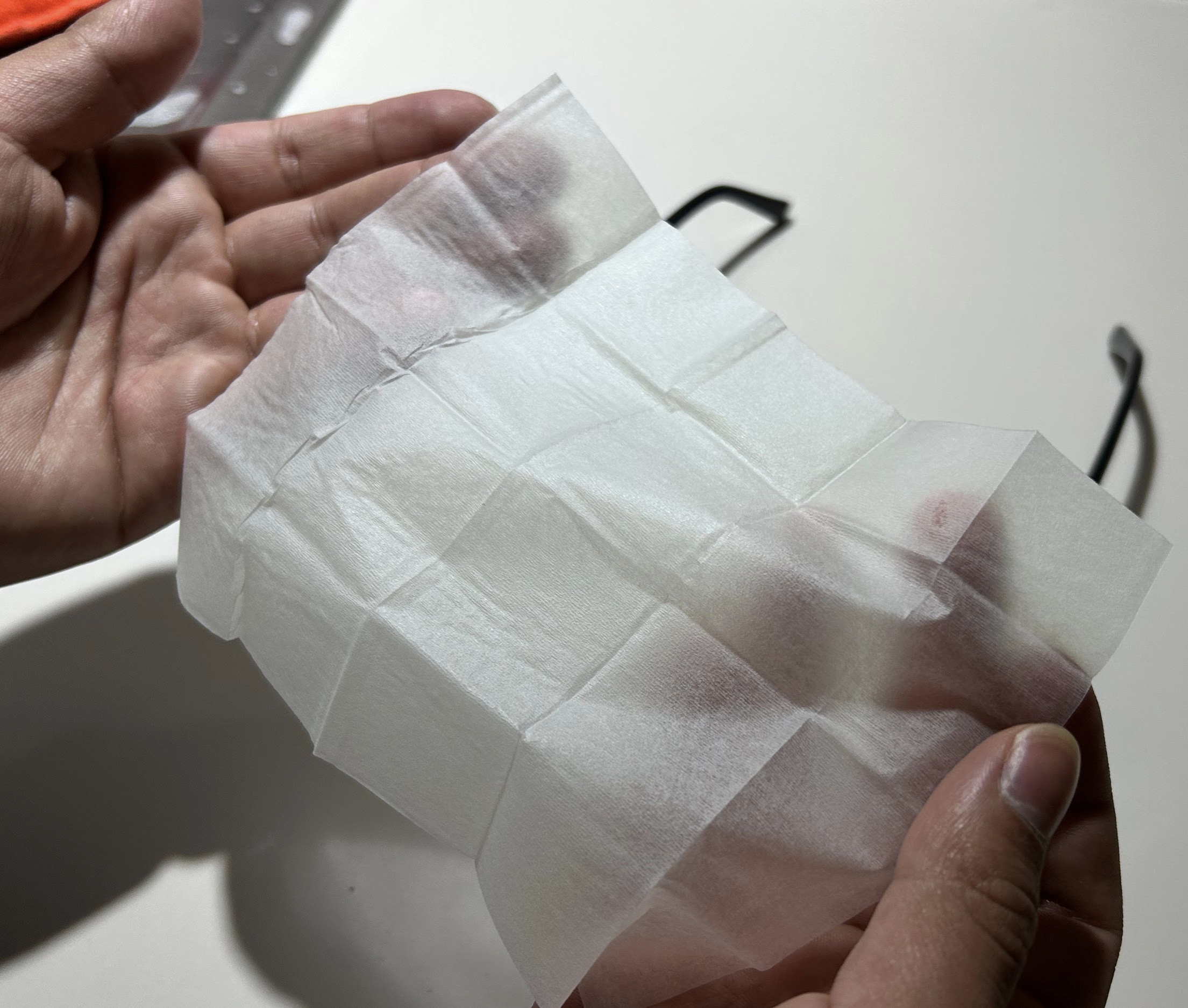 Using OPTI WIPES to clean eyeglasses